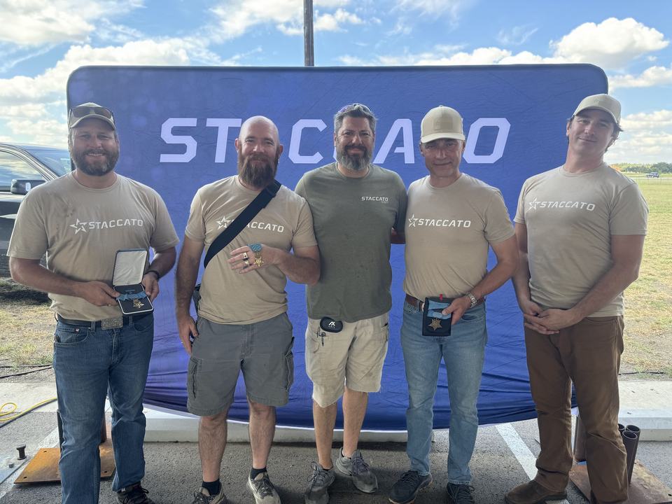 Jay Krug with four Medal of Honor recipients in front of a Staccato backdrop at The Great Americans Shoot